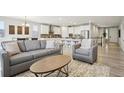 Open-concept living area boasts modern furnishings and seamless flow into the kitchen and dining space at 617 Iris St, Brighton, CO 80601