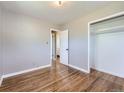 Cozy bedroom featuring hardwood floors, neutral-toned walls, and convenient access to an en-suite bathroom at 10736 Logan Ct, Northglenn, CO 80233