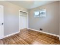 Bright bedroom with hardwood floors, neutral walls, and a closet perfect for storage and organization at 10736 Logan Ct, Northglenn, CO 80233