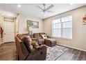 Relaxing living room with a cozy sectional sofa, a ceiling fan, and natural light from a large window at 765 N Shawnee St, Aurora, CO 80018