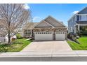 Charming home with stone accents, attached two-car garage, mature tree and inviting front porch at 11558 Pine Hill Way, Parker, CO 80138