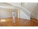 Open entryway featuring gleaming hardwood floors, a staircase with white risers, and arched doorways at 882 W 96Th Ave, Thornton, CO 80260