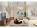 Bright living room with high ceilings, large windows, hardwood floors, and neutral decor at 882 W 96Th Ave, Thornton, CO 80260