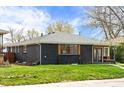 Exterior view shows the manicured lawn around the house and the roof's condition at 2276 Newland St, Edgewater, CO 80214