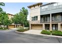 Modern townhome exterior showcasing stone accents, a balcony, and an attached garage at 13524 Via Varra, Broomfield, CO 80020