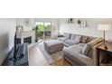 Spacious living room with a sectional sofa, fireplace, and balcony access at 3240 Iris Ave # G409, Boulder, CO 80301