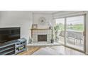Living room area showcasing a fireplace and sliding glass doors to a balcony at 3240 Iris Ave # G409, Boulder, CO 80301