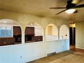 Living Room features a brick fireplace and open archways to other areas of the home at 4558 S Laredo St, Aurora, CO 80015