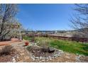Beautiful backyard with a stone patio, garden, and scenic views at 952 Eaglestone Dr, Castle Rock, CO 80104