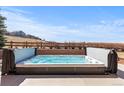 Relaxing hot tub surrounded by a brick wall and scenic views at 12092 S Great Plain Ct, Parker, CO 80134