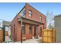 Charming two-story brick home featuring a covered entryway and well-maintained landscaping at 3643 Zuni St, Denver, CO 80211