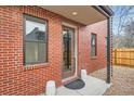 Inviting front entrance featuring brick facade, covered porch and stylish decor elements at 3643 Zuni St, Denver, CO 80211