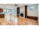 Spacious living room boasts hardwood floors, a fireplace, built-in shelves, and lots of natural light at 3643 Zuni St, Denver, CO 80211