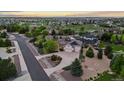 Aerial view of the home with lush landscaping, close to golf course and other neighborhood homes at 8211 E 128Th Pl, Thornton, CO 80602