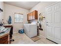 Functional laundry room featuring a washer, dryer, storage cabinets, and a sink, providing convenience and organization at 3413 Boxelder Dr, Longmont, CO 80503