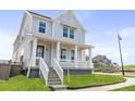 Beautiful two-story home featuring a classic covered porch and a lush green lawn at 251 Washington St, Erie, CO 80516