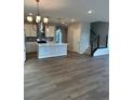 Open-concept kitchen with island, stainless steel appliances, stylish lighting, and modern finishes at 251 Washington St, Erie, CO 80516