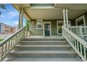 Inviting front porch with a staircase and covered area, perfect for relaxing at 9270 107Th E Pl, Commerce City, CO 80640