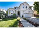 Charming two-story home with a well-manicured lawn, lovely landscaping, and a basketball hoop over the garage at 2880 Breezy Ln, Castle Rock, CO 80109