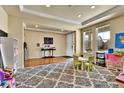Bright, spacious living room with hardwood floors and large windows, offering versatile layout options for relaxation at 10052 Isle St, Parker, CO 80134