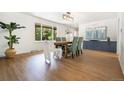 Bright dining room with view to outside, stylish decor, and hardwood floors at 1420 W Ridge Rd, Littleton, CO 80120