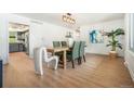 Bright dining room with modern light fixture, stylish decor, and hardwood floors at 1420 W Ridge Rd, Littleton, CO 80120