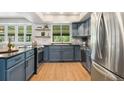 Bright kitchen boasts stainless steel appliances, ample cabinetry, and lots of light at 1420 W Ridge Rd, Littleton, CO 80120