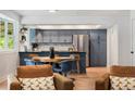 Eat-in kitchen features an island, stainless steel appliances, and stylish decor at 1420 W Ridge Rd, Littleton, CO 80120