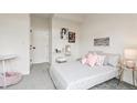 This cozy bedroom features a plush gray carpet, soft pink accents, and artful wall decor at 5367 W 14Th Ave, Lakewood, CO 80214