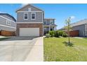 Well-maintained home featuring a two-car garage, brick accents, and a manicured front yard at 13644 Ulster St, Thornton, CO 80602