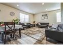 Open living room featuring modern decor, plush seating, and ample natural light at 13644 Ulster St, Thornton, CO 80602
