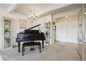 Inviting living room featuring a piano, chandelier, and neutral carpet at 8060 E Girard Ave # 712, Denver, CO 80231