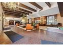 Spacious lobby featuring a fireplace, brick floors, and ample seating at 8060 E Girard Ave # 712, Denver, CO 80231