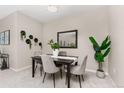 Elegant dining room featuring a dark wood table and gray chairs at 13456 Via Varra # 118, Broomfield, CO 80020