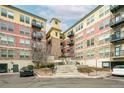 Modern apartment building with stone and red brick exterior at 13456 Via Varra # 118, Broomfield, CO 80020