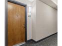 Apartment entry hallway with wood door and gray walls at 13456 Via Varra # 118, Broomfield, CO 80020