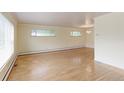 Spacious living room with hardwood floors, neutral paint, and an elegant chandelier at 353 S Niagara St, Denver, CO 80224