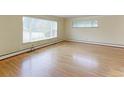 Bright living room features hardwood floors, large windows, and ample natural light at 353 S Niagara St, Denver, CO 80224