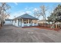 Charming bungalow with a newly renovated exterior, showcasing a front yard and driveway at 1765 Ingalls St, Lakewood, CO 80214