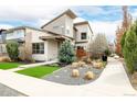 Modern home featuring unique architectural details, manicured lawn and decorative rock landscaping at 1848 W 68Th Ave, Denver, CO 80221