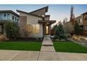 Contemporary home with unique architectural design and well-maintained landscaping and a modern front door at 1848 W 68Th Ave, Denver, CO 80221
