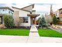 Contemporary home with modern architecture, an orange front door, and well-maintained landscaping at 1848 W 68Th Ave, Denver, CO 80221