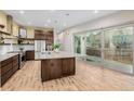 Modern kitchen featuring stainless steel appliances, granite counters, and an island with pendant lighting at 1848 W 68Th Ave, Denver, CO 80221