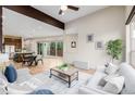 Bright, open-concept living room with hardwood floors and sliding glass doors to the outdoors at 1848 W 68Th Ave, Denver, CO 80221