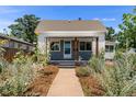 Charming bungalow with landscaped front yard and walkway at 1111 E Dartmouth Ave, Englewood, CO 80113
