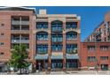 Street view of condo building, brick and windows at 2245 Blake St # L M N, Denver, CO 80205