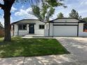 Charming one-story home with a well-maintained lawn and a two car garage at 10431 Holland St, Broomfield, CO 80021