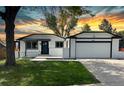 Charming single Gathering home featuring a landscaped front yard and an attached two-car garage at 10431 Holland St, Broomfield, CO 80021