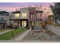 Contemporary two-story home featuring a landscaped front yard and a rooftop deck at 2723 Grove St, Denver, CO 80211