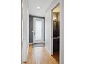Hallway with hardwood floors leading to a modern powder room at 2723 Grove St, Denver, CO 80211